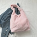 Chic pink fuzzy faux fur tote bag styled on denim jacket for casual daily use - Pink