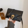 Black leather small crossbody bag with gold waterdrop clasp and V-shaped stitching - Black