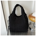 Close-up of black bubble textured fabric on a lightweight puff shoulder bag for women - Black