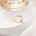 Elegant six-prong 18k gold plated titanium ring with single zircon on white stand - US 3 / Gold