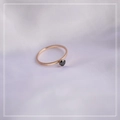 Macro detail of minimalist rose gold ring with a four-prong set black gemstone - US 3 / Rose Gold with Black Zirconia