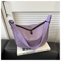 Detail shot of purple quilted nylon crescent bag with textured diamond stitching and black zippers - Purple