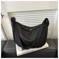 Detail of black quilted nylon crescent bag with wide strap and double zippers - Black