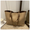 Close-up of beige woven texture and dark brown leather trim on a large tote bag - Khaki