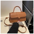 Close-up of brown crocodile pattern handbag showing detailed PU leather texture and gold buckle - Brown