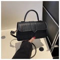 Detailed view of black crocodile pattern faux leather texture on a stylish square bag - Black