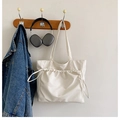 Detail of white waterproof tote bag with drawstring texture and slim shoulder straps - White