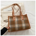 Detail of vintage brown plaid tote bag with leather handles and gold metal rivets - Brown