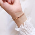 Close-up of rose gold minimalist flat bangle with polished finish on a female wrist - Diameter 55-Rose Gold