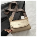 Detail of champagne gold leather bag with textured finish and geometric patterned strap - Gold