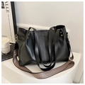 Detail of black faux leather tote bag with wide vintage woven strap and embossed logo - Black