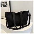 Detail of black corduroy tote bag showing vertical ribbed texture and detachable strap - Black