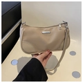Detail of beige nylon crescent bag with silver zipper and rectangular metal logo plate - Khaki