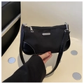 Close-up of black nylon underarm bag with silver zipper and white stitching detail - Black