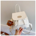 Detail of white PU leather backpack with drawstring closure and brown plush monster charm - Off White