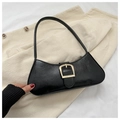 Macro detail of black leather baguette bag with vintage gold metal buckle accent - Black