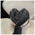 Detail view of heart-shaped black crossbody bag with silver studs and chain strap - Black