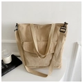 Detail of beige corduroy tote bag showing front flap pocket and adjustable strap texture - Khaki