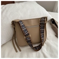 Macro detail of khaki leather tote bag featuring a wide jacquard pattern shoulder strap - Khaki