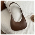 Close-up of dark brown leather crescent shoulder bag with silver Fashion text on fabric - Brown