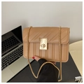 Detail of khaki quilted chain bag featuring a gold rectangular twist lock and PU texture - Khaki