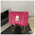 Chic magenta quilted crossbody bag with gold chain strap and metal lock on a desk - Rose Pink