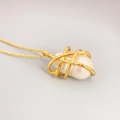 French vintage baroque pearl pendant necklace with gold plated chain on grey background - Necklace
