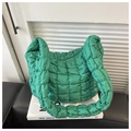 Close-up of green quilted bubble nylon shoulder bag featuring puffy square stitch texture - Green