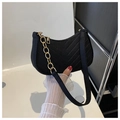 Close-up of black crescent felt bag with V-quilted texture and gold chain detail - Black