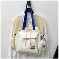 Detail of canvas bucket bag with drawstring closure and small round pendant pouch - Off White