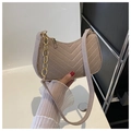 Detail of beige quilted felt shoulder bag with gold chain and chevron texture - Khaki