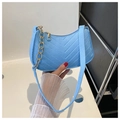 Close-up of sky blue felt bag with V-shaped quilting and a gold chain handle - Lake Blue