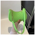 Macro shot of V-shaped quilted lime green felt texture and decorative golden chain strap - Fluorescent Green