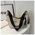 Detail of cream nylon tote bag featuring durable black adjustable strap and dual rope zippers - Khaki