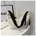 Detail of white nylon tote bag featuring black wide strap and woven cord zipper pull - White