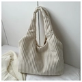 Detailed view of the soft white corduroy fabric texture on a large minimalist tote bag - White
