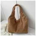Detail view of large brown corduroy tote bag showing its rich vertical ribbed texture - Khaki