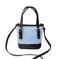 Blue canvas bucket bag with black leather trim and adjustable straps for crossbody use - Blue