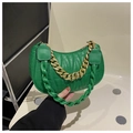 Detail of green quilted half-moon bag featuring a chunky gold chain and woven strap - Green