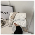 Detail of white quilted crossbody bag with chevron pattern wide strap and focus decor - White