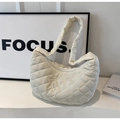 Detail view of cream quilted puffer tote bag featuring modern rhombus stitching and soft texture - Off White