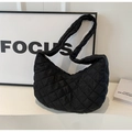Close-up of black quilted nylon moon bag with smooth metal zipper and wide padded strap - Black