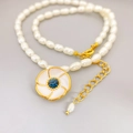 Elegant cultured pearl necklace with an enamel sunflower pendant and blue rhinestone - White