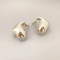 Polished silver heart stud earrings in minimalist 3D design on neutral background - White Gold