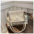 Detail of the rectangular metal nameplate and matte texture on the soft PU tote bag - Light Gray