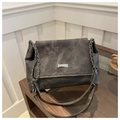 Close-up of vintage washed canvas tote bag with silver chain strap and metal logo - Dark Gray
