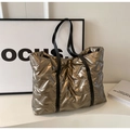 Chic quilted metallic bronze tote bag with puffy cloud texture and black straps - Champagne