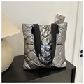Quilted silver tote bag with black straps in a stylish minimalist home setting - Gray