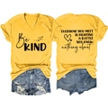 Flat lay of yellow V-neck tee with Be Kind print and distressed denim shorts set - S / Yellow