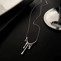 Irregular lava drop pendant necklace in polished silver finish on a minimalist display - Steel
